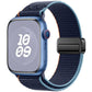 Apple Watch with a navy woven nylon loop band, blue trim, and black magnetic buckle