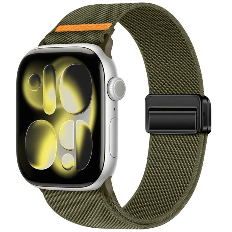 Dark olive nylon watch band with orange stitch detail and double magnetic buckle, shown on a watch