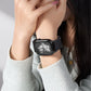 Black nylon Apple Watch band with magnetic buckle, shown worn on a wrist