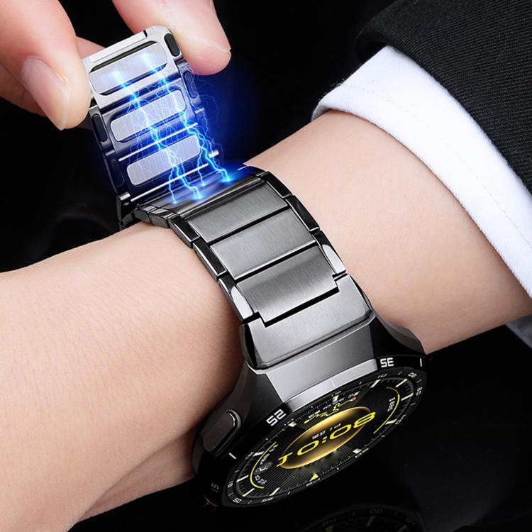 Dark stainless steel watch band fastening around wrist with magnetic links