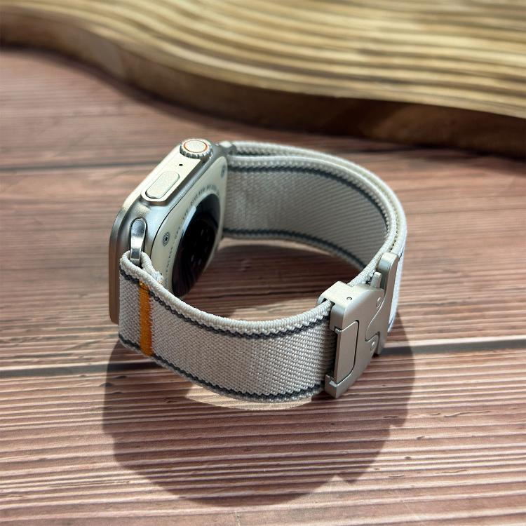 Starlight woven nylon Apple Watch band shown looped, with gray stitching and side buckle