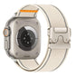 Cream woven nylon Apple Watch band with textured fabric, gray stitching and orange accent
