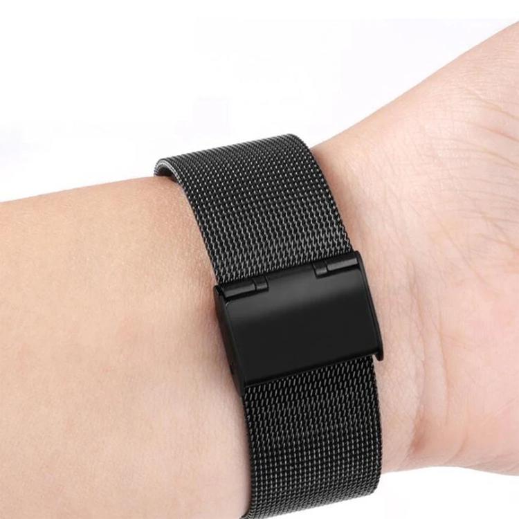 Black stainless steel mesh watch band fastened around a wrist