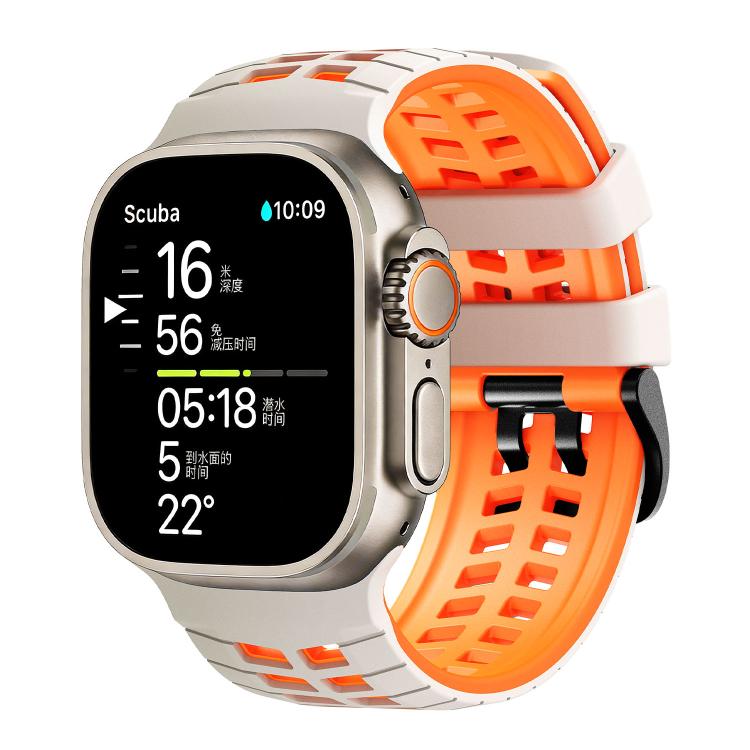 White and orange perforated silicone watch band fitted to a smartwatch.