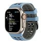 Light blue and dark gray perforated silicone watch band fitted to a smartwatch.