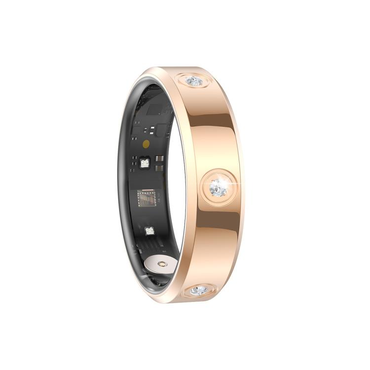 Reverse view of a gold-tone smart ring showing inner sensors and clear stones.