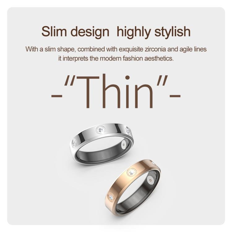 Slim smart ring in silver and gold tones with small clear stones and visible inner sensors.
