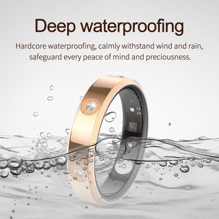 Gold smart ring with a polished band, sensor details, and dark inner lining