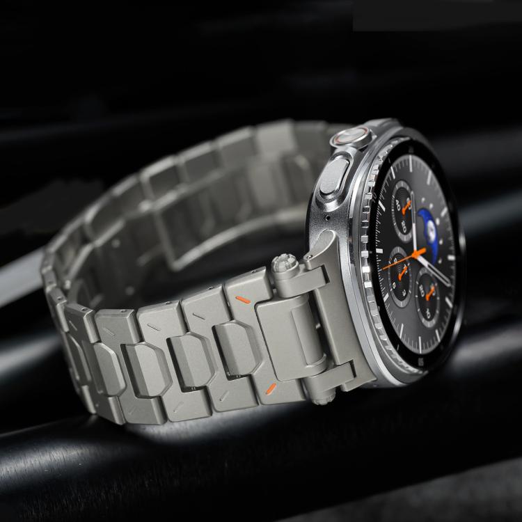 Silver titanium alloy watch band with chunky links and butterfly clasp, shown close up
