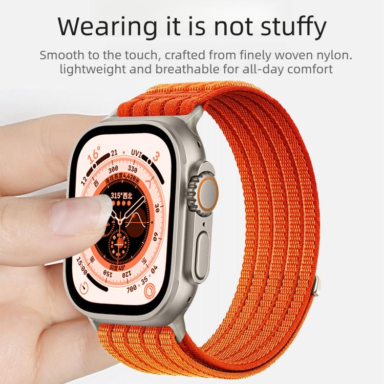 Orange woven nylon Apple Watch band worn around the wrist