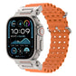 Orange perforated silicone watch band with metal connectors on a compatible watch.