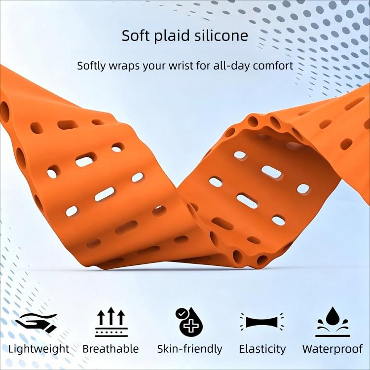 Orange perforated silicone watch band shown flexed to display its ventilation holes