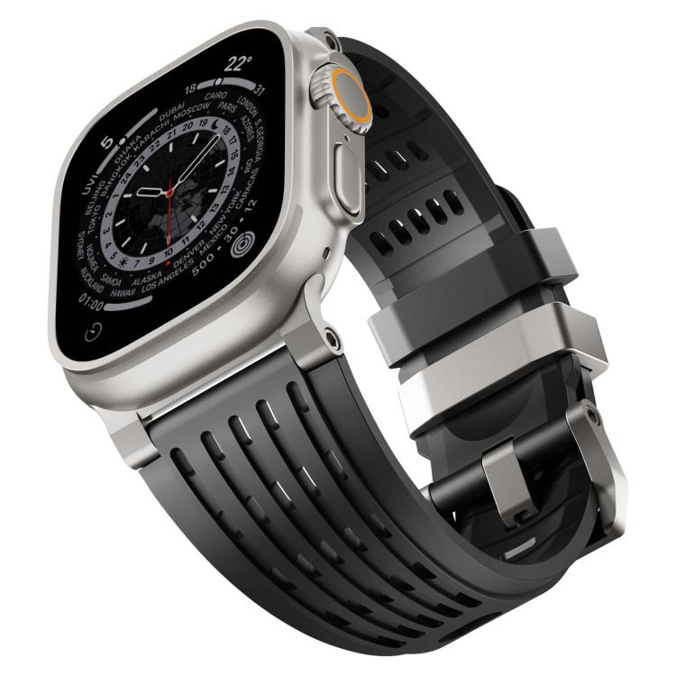 Black perforated silicone watch band with stainless steel double-ring buckle on an angled watch