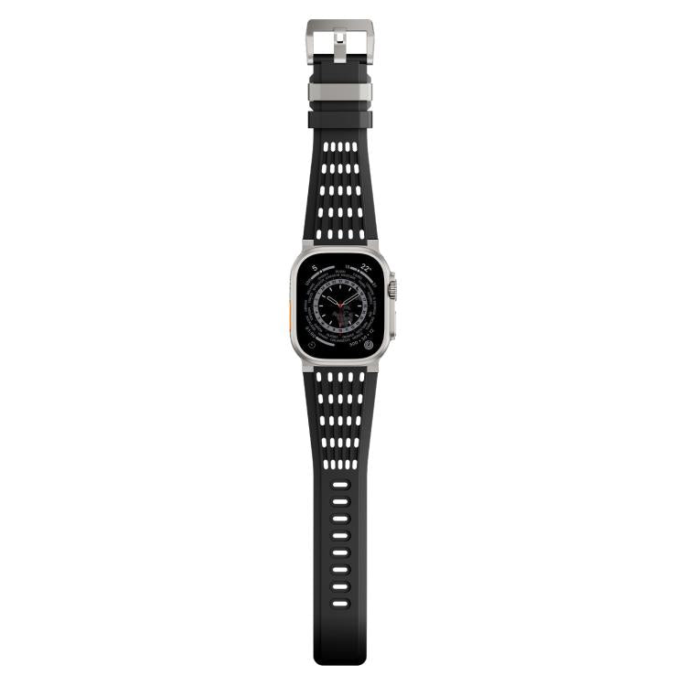 Black perforated silicone watch band with stainless steel buckle, shown full length on a watch