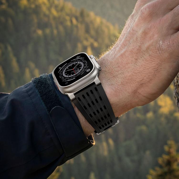 Black vented silicone Apple Watch band worn on the wrist