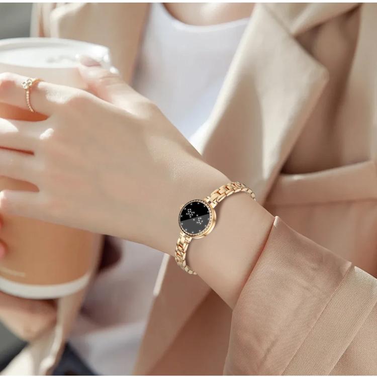 Rose gold smart bracelet worn on the wrist, with a round black display and linked band