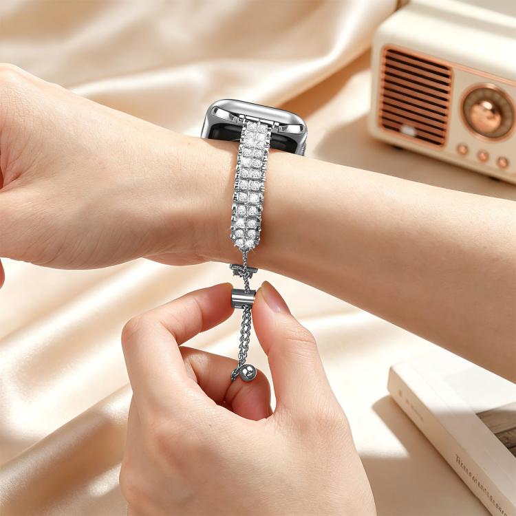 Silver diamond watch band being adjusted on a wrist