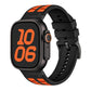 Apple Watch silicone band in black with bright orange contrast inserts.