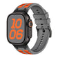 Gray silicone Apple Watch band with orange accents, shown fitted to a watch