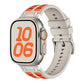 Silicone watch band in light gray with orange accent inlays, shown fitted on a watch