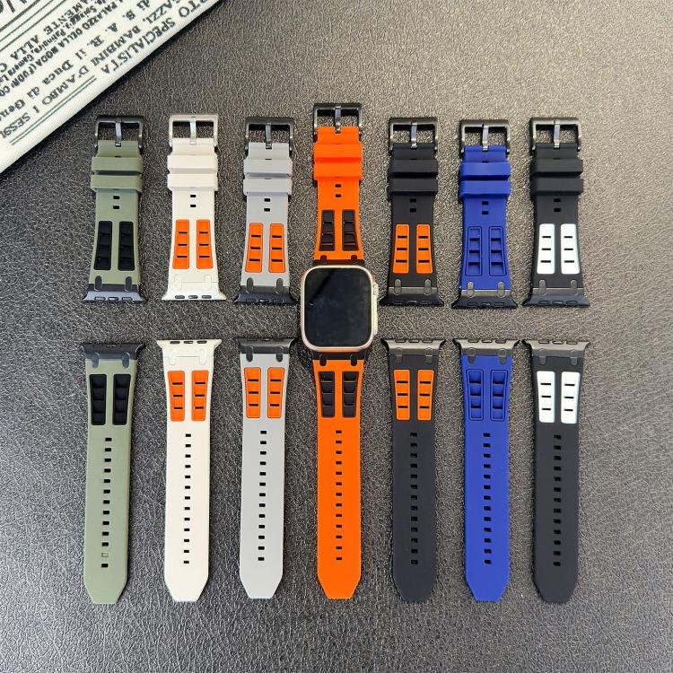 Assorted silicone watch band straps in solid and contrast colors, laid out with buckles