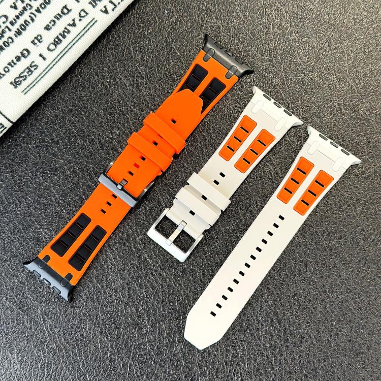 Orange and white silicone Apple Watch band pieces with black contrast details