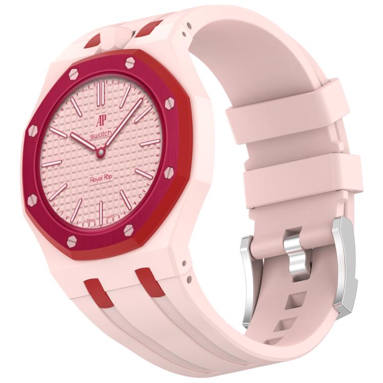 Pale pink silicone watch with red accents, textured dial, and stainless steel buckle