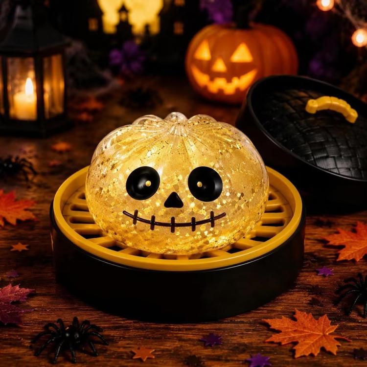 Glittery golden pumpkin-face dumpling squishy stress relief toy with black eyes
