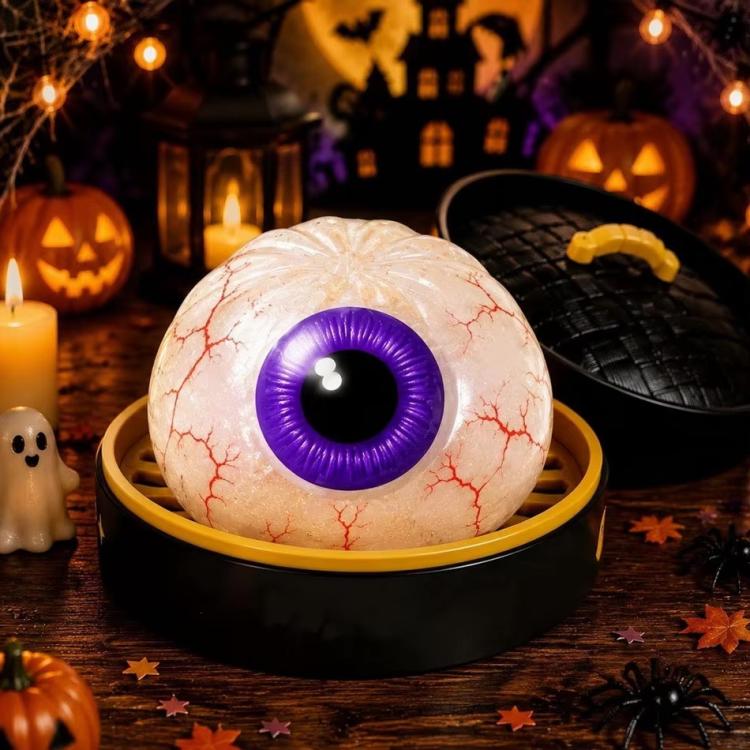 White eyeball dumpling squishy stress relief toy with purple iris and stitched mouth
