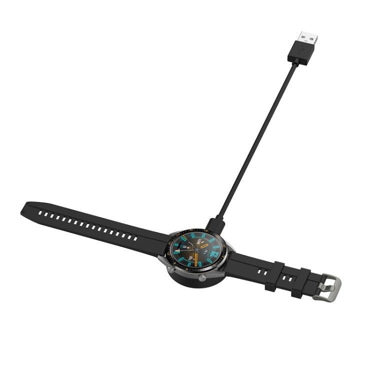 Smartwatch charging with black USB magnetic cable connected to watch