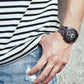 OCHSTIN men’s multi-function watch on wrist, dark dial with red accents and steel band