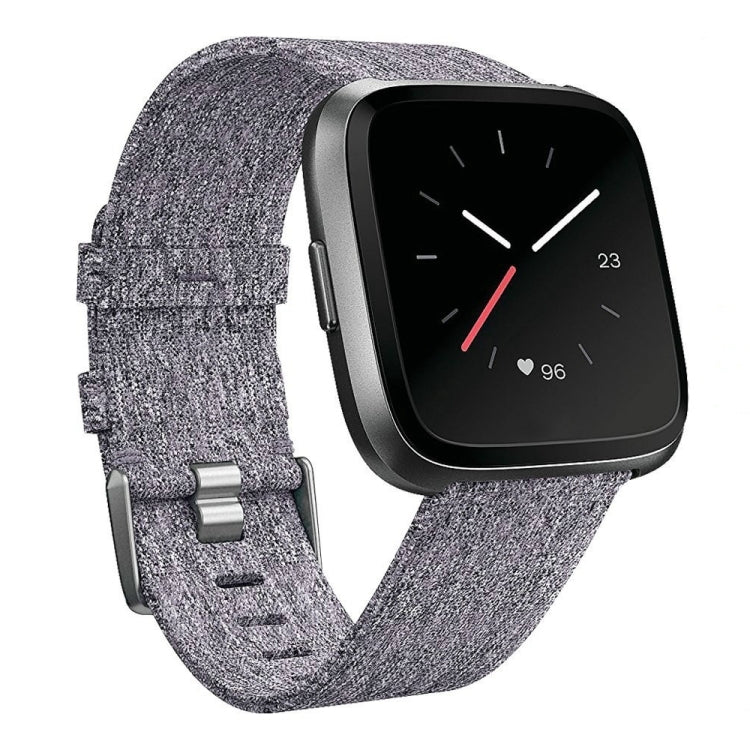 Gray nylon canvas smartwatch strap with metal buckle and textured fabric weave, adjustable fit