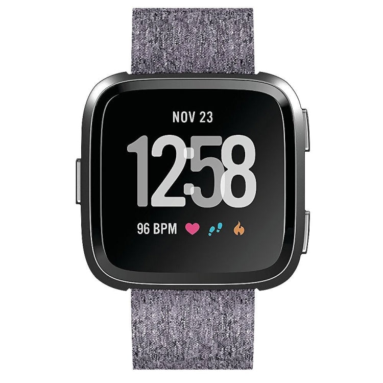 Gray nylon canvas smartwatch strap detail with clasp-side attachment and watch frame