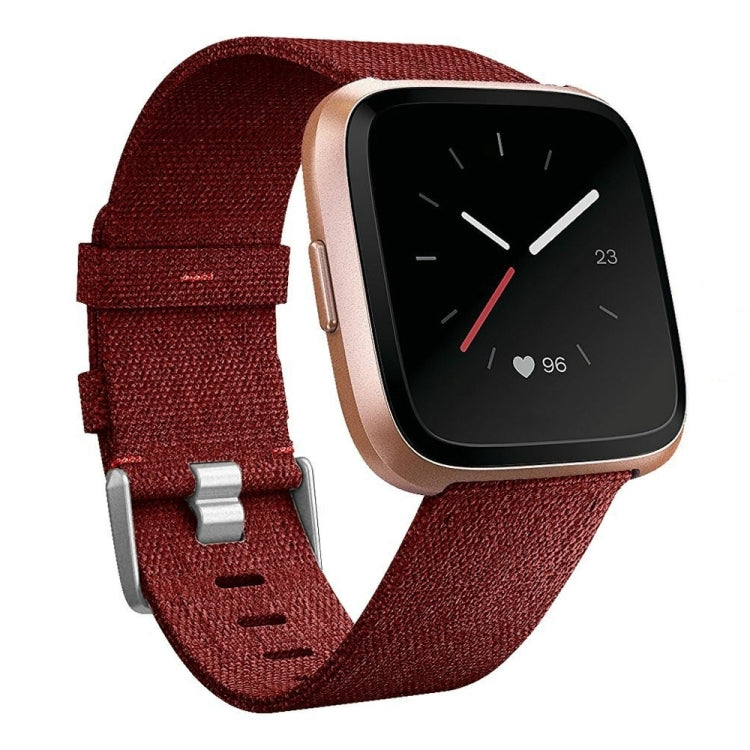 Red nylon canvas smartwatch strap with metal buckle, textured weave, adjustable holes