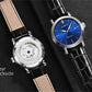 Two men's automatic watches: clear-back silver and blue dial on black leather straps