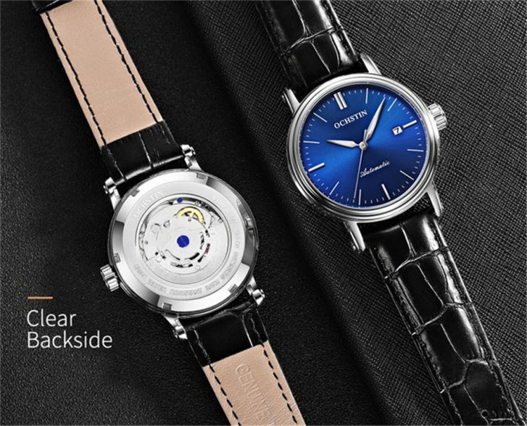 Two men's automatic watches: clear-back silver and blue dial on black leather straps