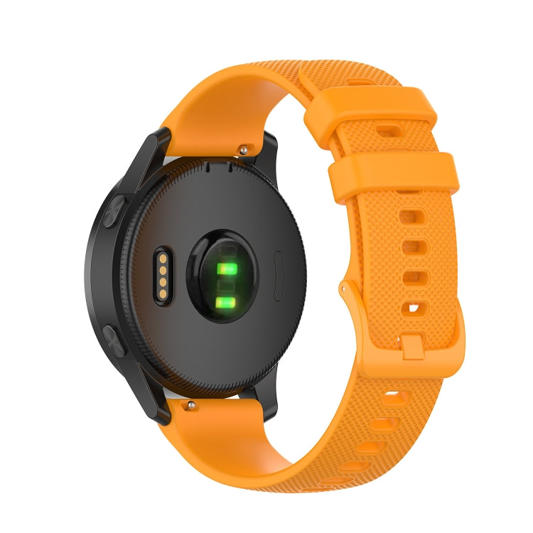 Silicone watch strap in bright orange with textured holes and two-tone buckle pieces