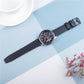 Black carbon fiber leather watch strap with buckle, on blue background