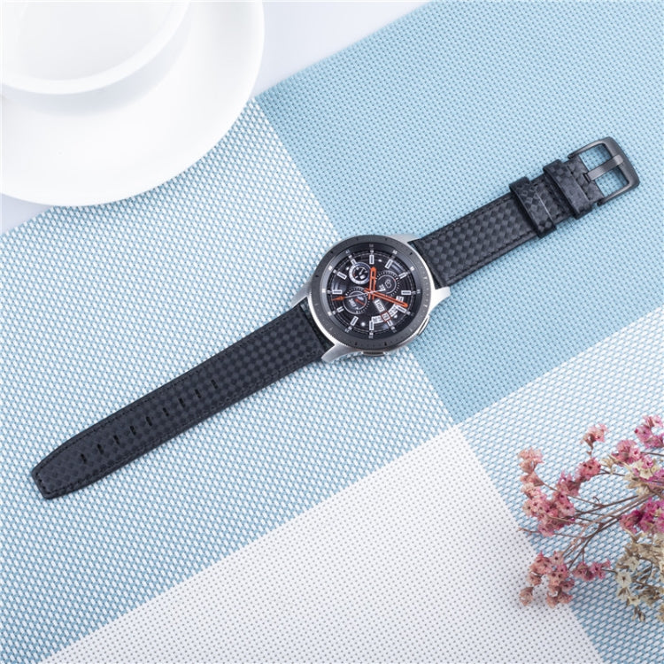 Black carbon fiber leather watch strap with buckle, on blue background