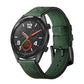 Green leather watch strap with orange stitching, punched holes, and metal buckle.