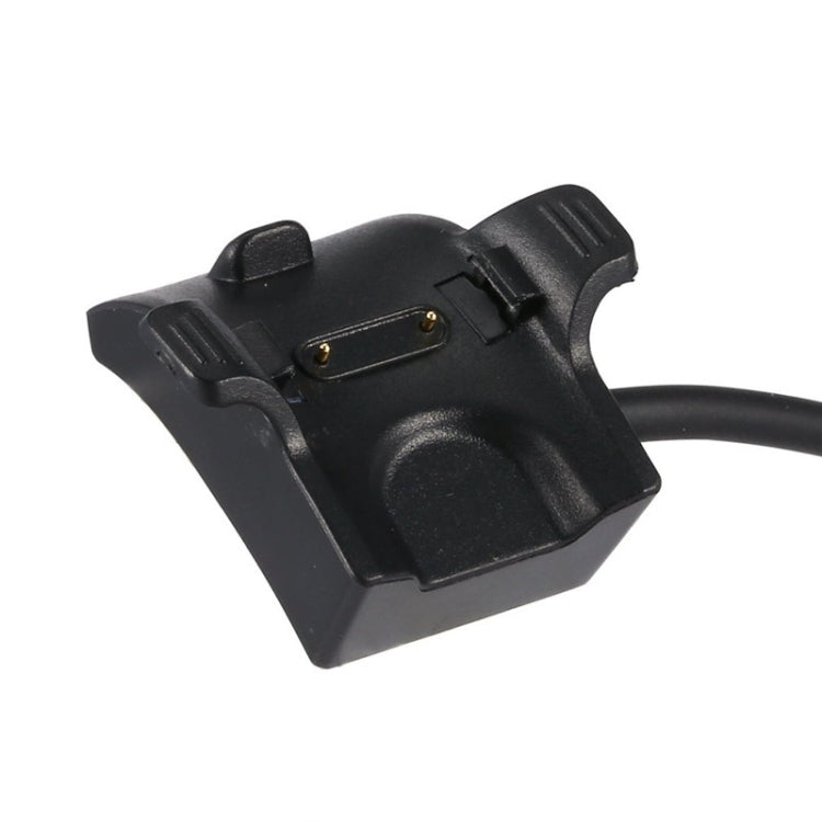 Black charging dock with gold contact pins and attached cable