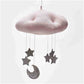 Pink plush cloud ceiling mobile with dark gray stars and a crescent moon ornament
