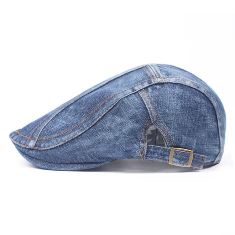 Washed denim beret side view with adjustable buckle strap and stitched crown panels