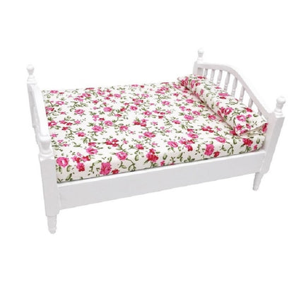 White mini doll bed with floral mattress bedding and raised side rails