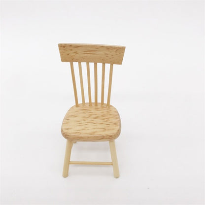 Miniature wooden dollhouse chair with slatted back and rounded seat.