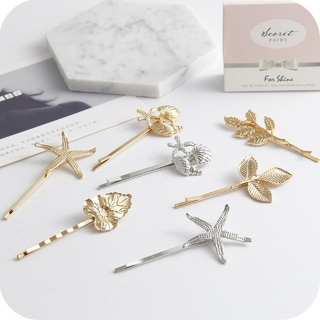 Set of gold and silver hair clips with starfish and leaf motifs