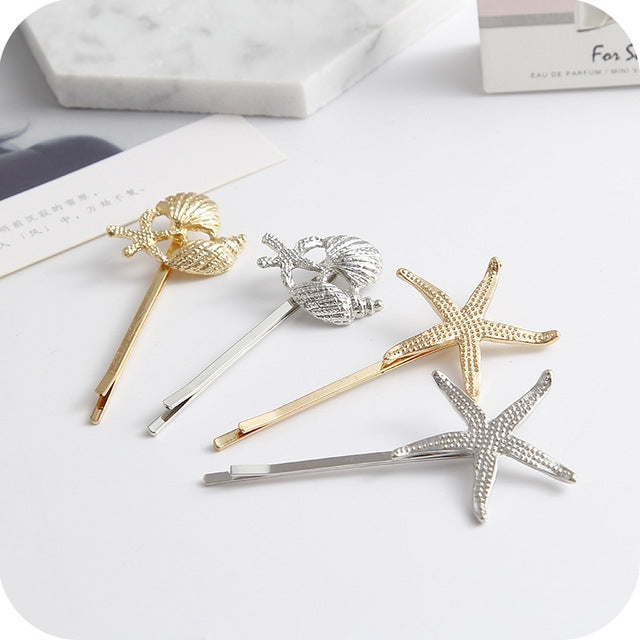 Set of gold and silver hair clips with starfish and leaf motifs