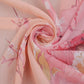 Peach pink chiffon scarf closeup with botanical floral pattern, lightweight sheer