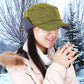 Mustard corduroy bomber hat worn by person with winter coat