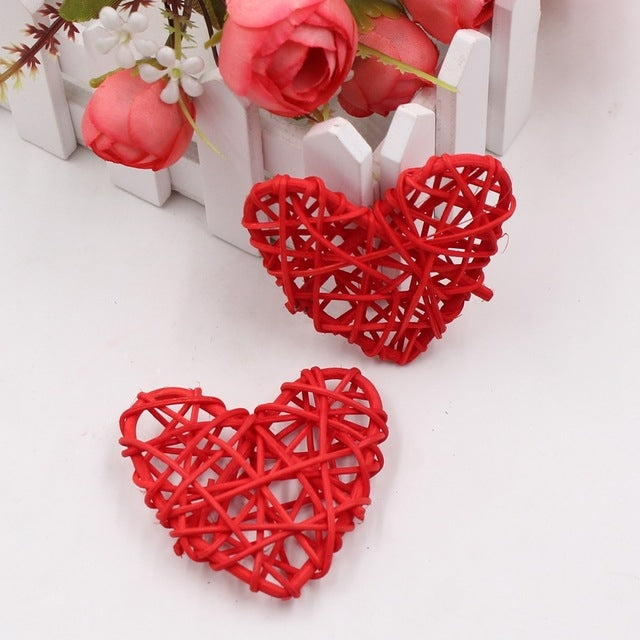 Red rattan heart ornaments, two woven straw hearts with crisscross lattice.